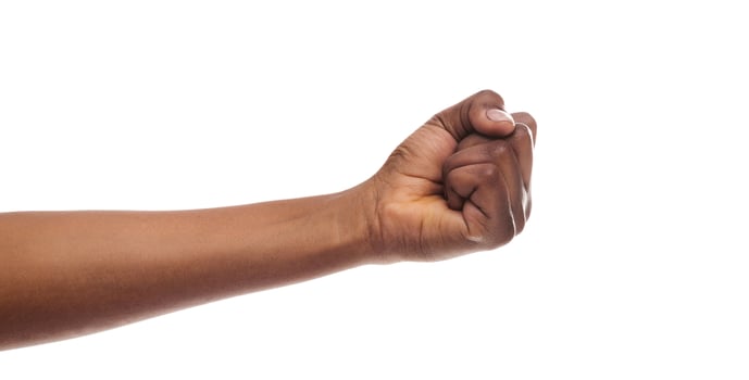 Counting, aggression, brave concept. Black female fist, clenched hand, isolated on white background. photo