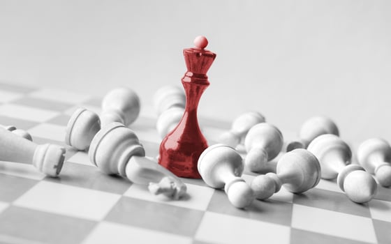 Black chess queen beats whites on chessboard over white background. Win and success concept, copy space photo