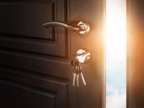 Half open door with keys in keyhole. Doorway to heaven and success. Entrance or exit, dreams and freedom conceptual background photo