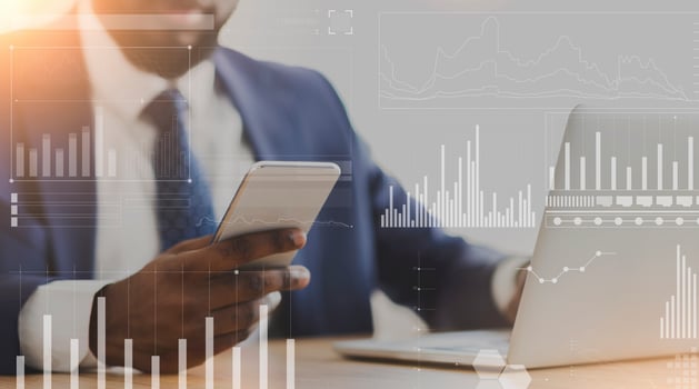 African American businessman using cellphone and laptop at workplace, collage with company analytics on imaginary screen. Online business management or marketing strategies concept photo