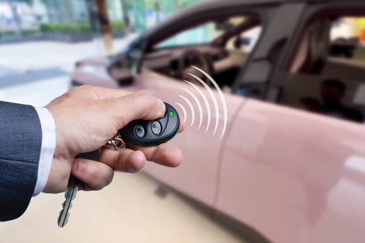 Men's hand presses on the remote control car alarm systems photo