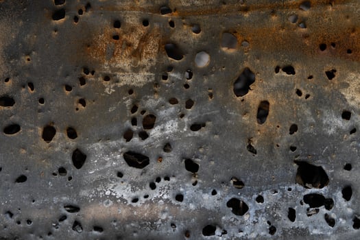 Texture of rusty iron with shrapnel damage for background. photo