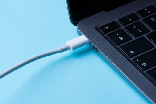 Laptop power. Cable with modern connector for charging and syncing your laptop with gadgets. Close-up. photo