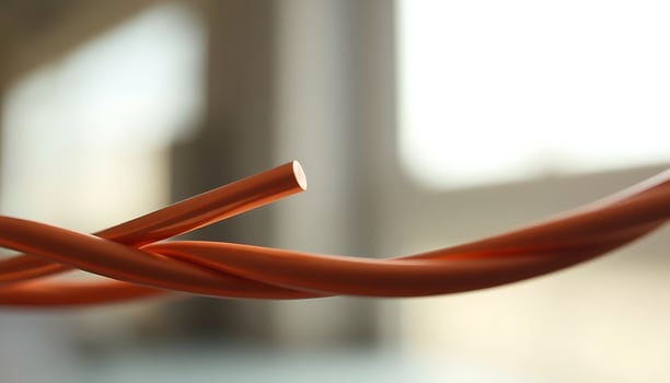 close up of a red wire with a blurry background photo
