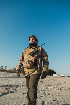Blue Sky Over A Soldier Walking On The Beach photo