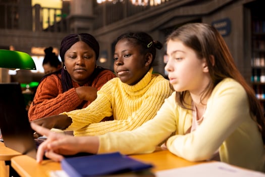 African american mentor guiding young learners through schoolwork and assignments, emphasizing diverse teaching methods and effective communication. Professor tutoring her pupils after class. photo
