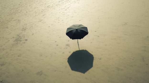 Black Umbrella Shadow on Sandy Beach photo