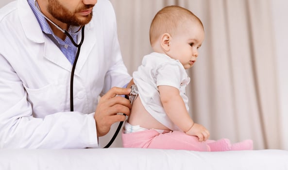 Medical Checkup. Doctor Examining Baby Girl Listening To Her Lungs Using Stethoscope In Hospital. Ill Little Patient Having Pediatrician Appointment In Clinic. Child Healthcare Concept. Cropped photo