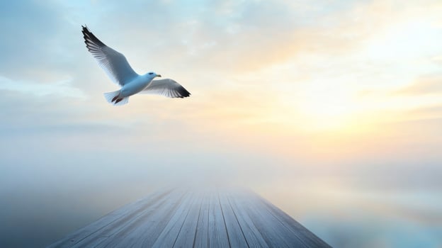 Seagull in Flight Over Foggy Water at Sunrise photo