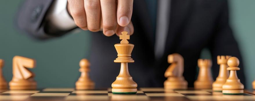 A hand moves the king chess piece in a strategic game setting. Business growth expansion and efficiency concept. photo