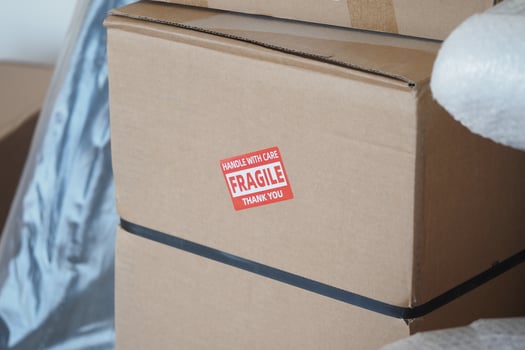 Handling fragile boxes with care during a move in a new home photo