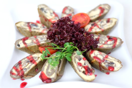 meatloaf slices Colorful stuffed rolls gourmet Middle Eastern dish featuring crispy stuffed rolls topped with creamy yogurt and pistachios, drizzled sauce and garnished with fresh greens. photo