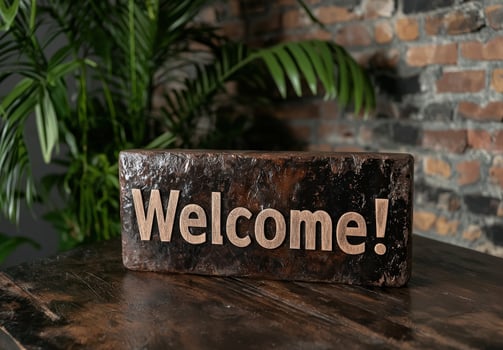 Rustic welcome sign on wooden table with plants photo