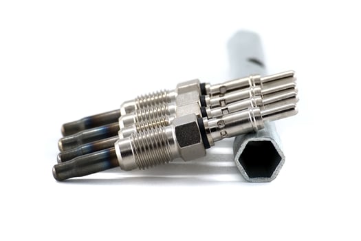 Automotive glow plugs with a wrench isolated on white background, detailed mechanical view. photo