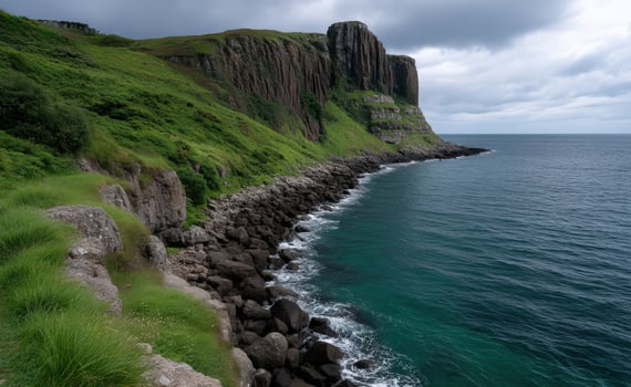 Dramatic coastal cliffs meet the turquoise sea under moody sky photo