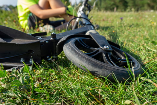 Close-Up of a Scooter in a Sunny Outdoor Setting on Grass photo