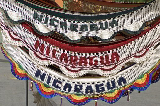 A clock with a bunch of different colored knitted banners photo