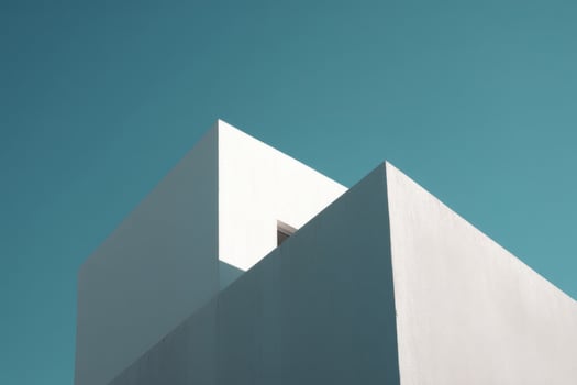 Part of white building against blue sky photo