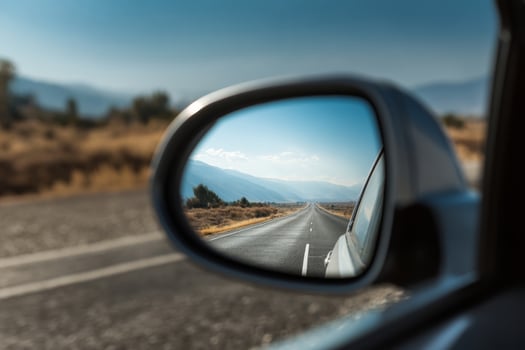 Scenic road in rearview mirror during road trip photo