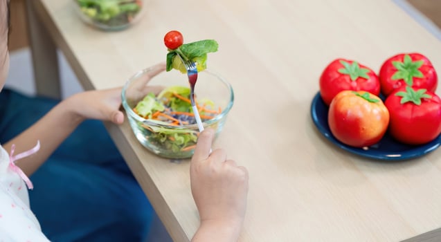 Wellness and nutrition. Child enjoying a colorful salad photo