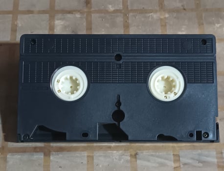 Black VHS Tape on a Checkered Surface photo