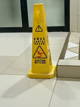 Yellow Wet Floor Sign in a Tiled Area photo