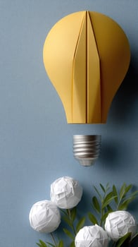 A yellow light bulb with white paper flowers photo