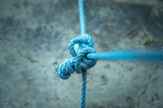 A powerful visual asset for content focused on hiking, climbing, emergency preparedness, or sea travel. The knots detail enhances themes of preparation, strength, and tactical readiness. photo