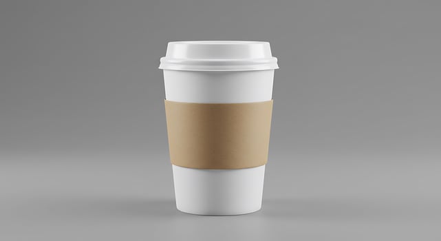 A white coffee cup with a brown paper sleeve photo