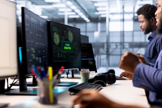 Developer receiving access granted notification while reconfiguring server farm, optimizing it. Worker ensures data center operates efficiently, happy after successfully eliminating all errors photo