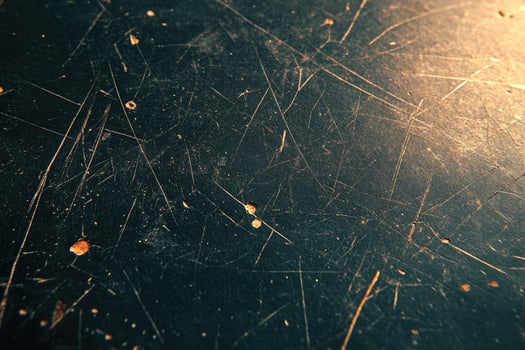 Close-up view of a dark surface with scratches and marks. photo