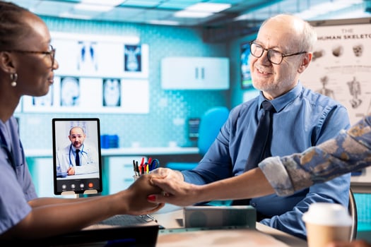African american nurse doing comforting gesture for senior people on web call with specialist, holding hands with patients and encouraging them while they discuss with doctor remotely. Telemedicine. photo