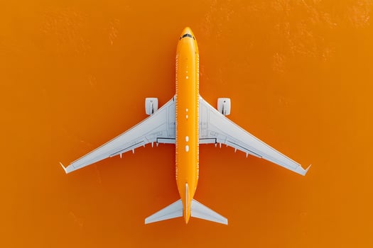 Aerial View of a Bright Orange Airplane Flying Over a Vibrant Orange Surface, Capturing the Sleek Design and Modern Aesthetics of Aviation Technology photo