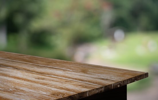 a wooden table with a blurred background photo