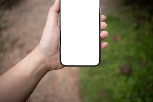 Smart phone mockup. Women hands holding cell telephone with blank copy space screen smartphone blank white screen isolated technology concept. photo