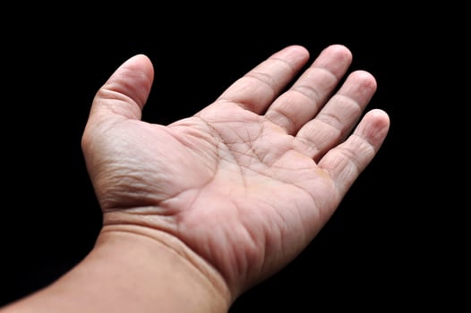 Asian man palms wide open fingers black background photo