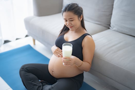 Pregnant asian woman drinking milk relaxation and Self-care Pregnancy drinking a glass of fresh milk mother mindfulness Positive life moment in pregnancy time photo