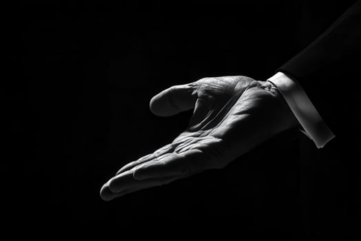 Elegant black and white image of a hand reaching out, symbolizing invitation or assistance photo