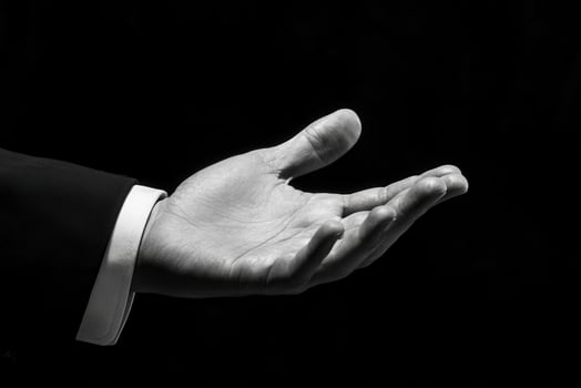 Elegant outstretched hand in a formal setting, symbolizing invitation and connection photo