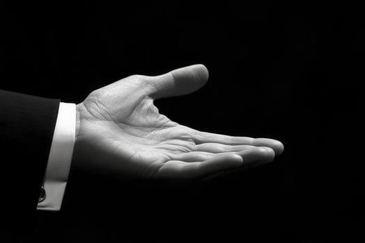 Elegant open hand gesture in black and white, symbolizing invitation or offering photo
