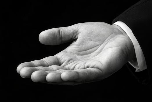 Elegant black and white image of an open hand, symbolizing invitation or assistance photo