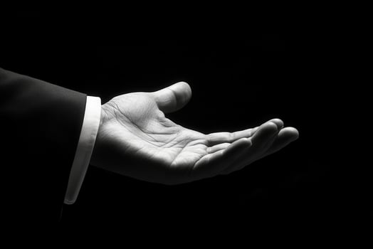 Elegant outstretched hand in black and white, symbolizing invitation or assistance photo