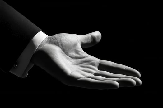 A black and white photo of a hand reaching out