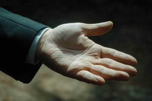 Outstretched hand in a formal setting, symbolizing greeting or offering assistance photo