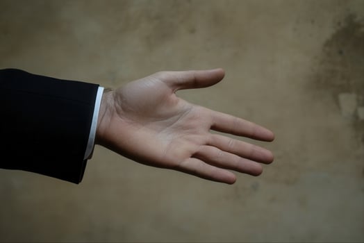 Open hand gesture against a textured background, symbolizing greeting or offering help photo