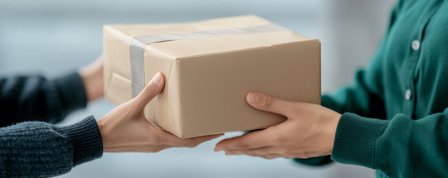 Customer experience and engagement service quality concept. Package delivery between two hands in a bright setting photo