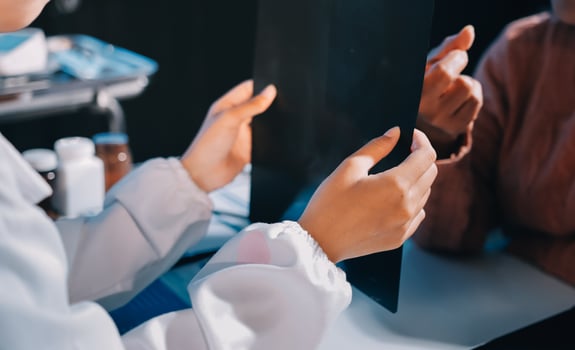 A doctor examining a patient's x - ray photo