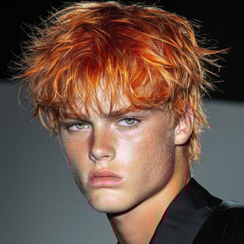 Intense portrait of a young man with fiery red hair photo