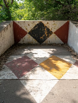 Weathered diamond pattern on a concrete structure outdoors photo