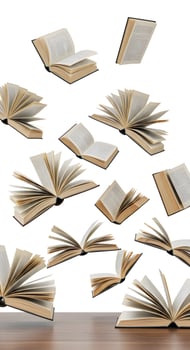 Many open books are flying in the air photo